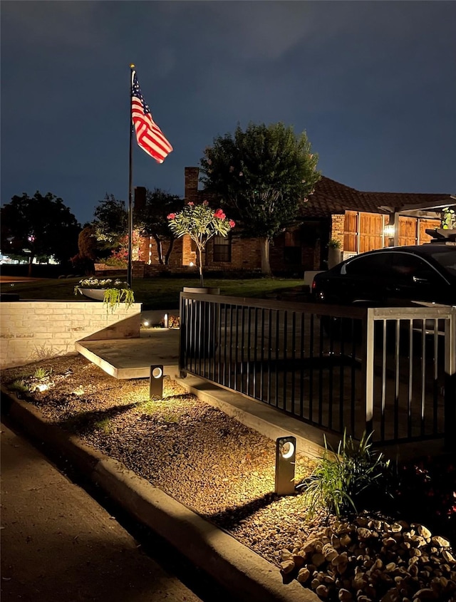 view of gate at twilight