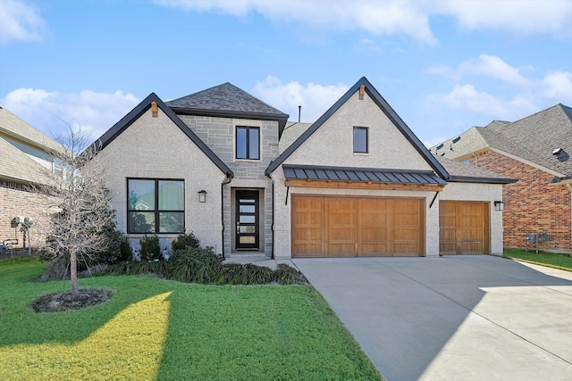 view of front of home featuring a garage and a front yard