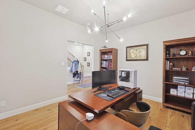 office area featuring an inviting chandelier and light hardwood / wood-style floors