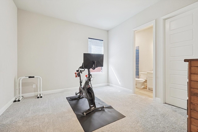 workout room featuring light colored carpet