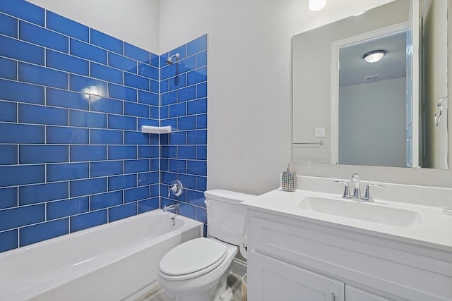 full bathroom with vanity, tiled shower / bath combo, and toilet