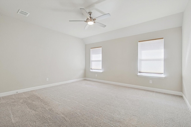 spare room featuring ceiling fan, vaulted ceiling, and light carpet