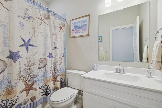 bathroom with vanity, toilet, and a shower with shower curtain