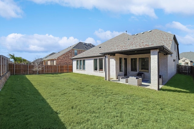 rear view of property with a yard, an outdoor hangout area, and a patio