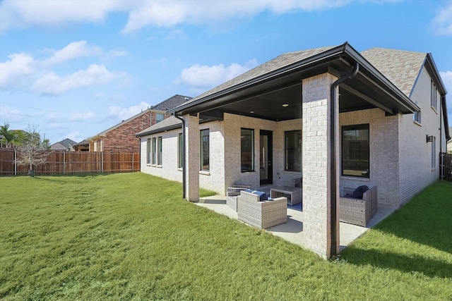 back of house featuring a yard, an outdoor hangout area, and a patio area