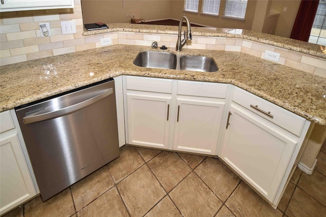 kitchen with white cabinetry, dishwasher, sink, and tasteful backsplash