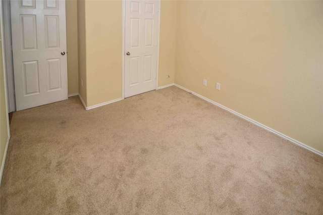 unfurnished bedroom featuring light carpet