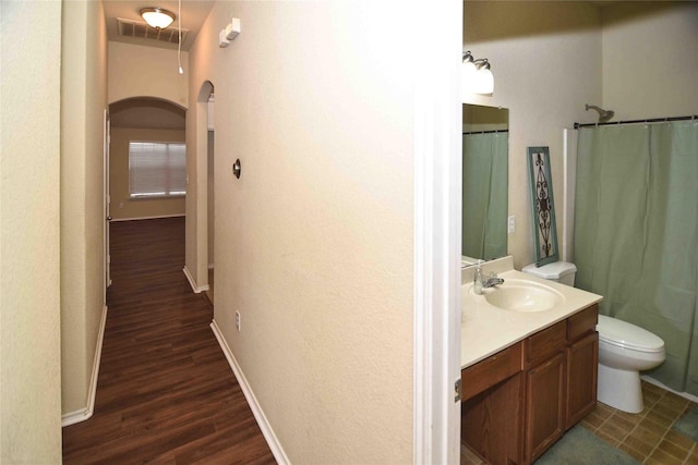 bathroom with vanity, wood-type flooring, and toilet