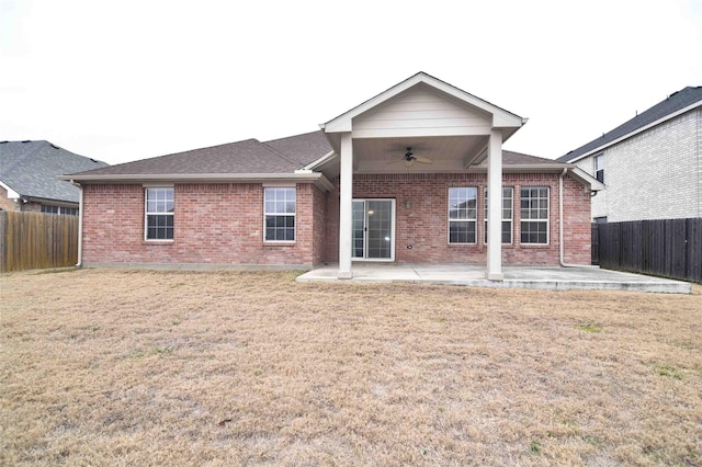 back of house featuring a yard, ceiling fan, and a patio area