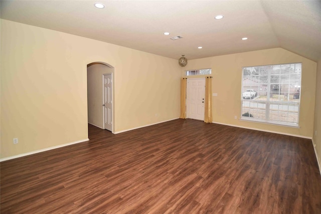 empty room with lofted ceiling and dark hardwood / wood-style flooring