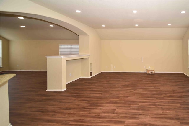 empty room featuring dark hardwood / wood-style flooring and vaulted ceiling