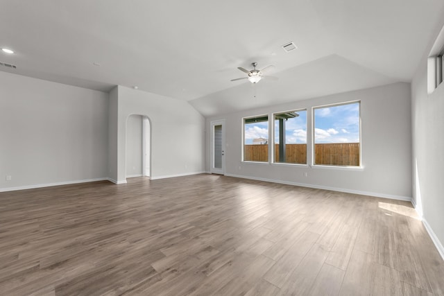 unfurnished room with wood-type flooring, vaulted ceiling, and ceiling fan