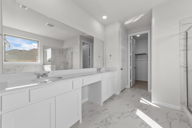 bathroom with vanity and a shower with shower door