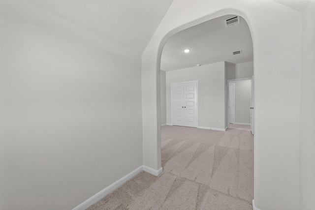 hallway with light colored carpet