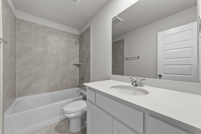 full bathroom featuring tiled shower / bath, vanity, and toilet