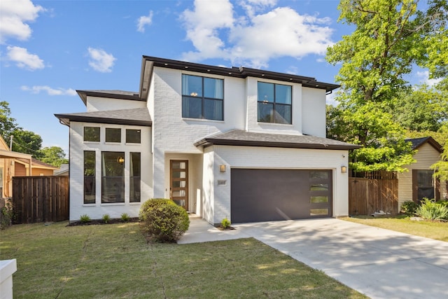 view of front of house featuring a garage and a front yard