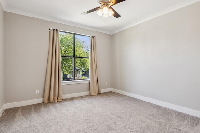 empty room featuring ornamental molding, carpet flooring, and ceiling fan