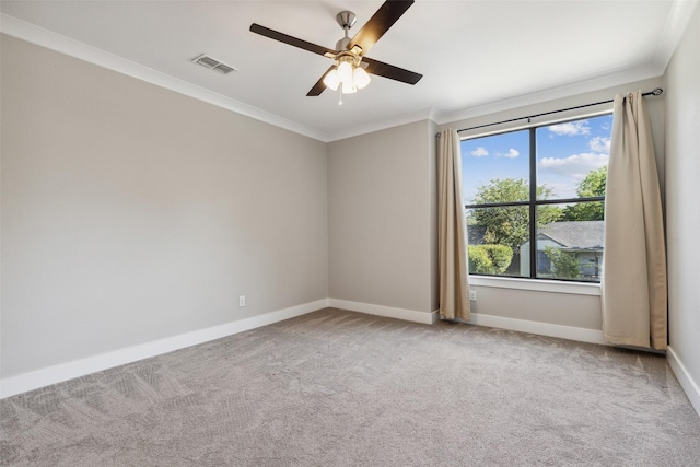 carpeted spare room with ornamental molding and ceiling fan