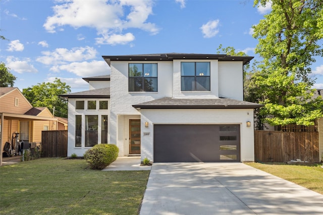 prairie-style home featuring a garage and a front yard