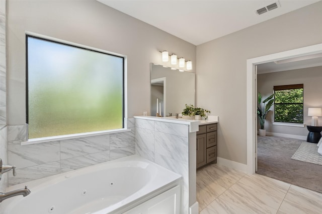 bathroom with vanity and a tub