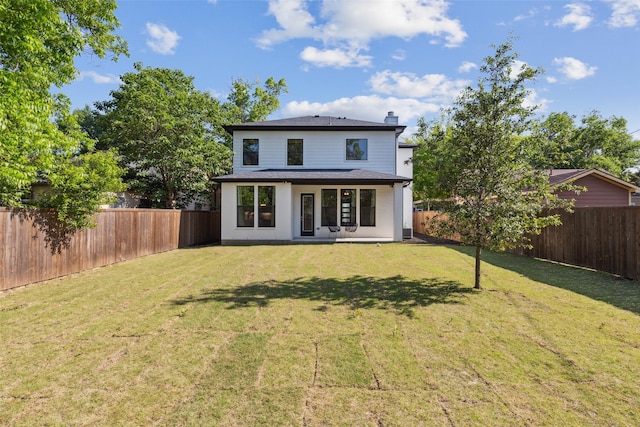 back of house with a lawn