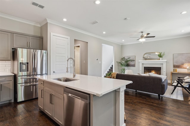 kitchen featuring appliances with stainless steel finishes, dark hardwood / wood-style floors, an island with sink, sink, and gray cabinetry