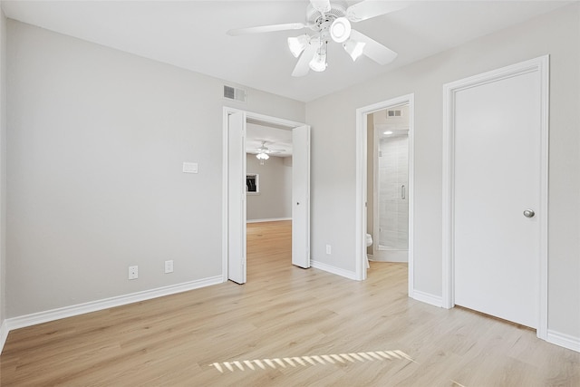 unfurnished bedroom featuring ceiling fan, ensuite bath, and light hardwood / wood-style flooring