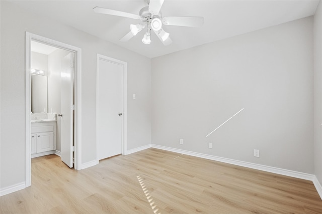 unfurnished bedroom with ensuite bathroom, ceiling fan, and light hardwood / wood-style floors