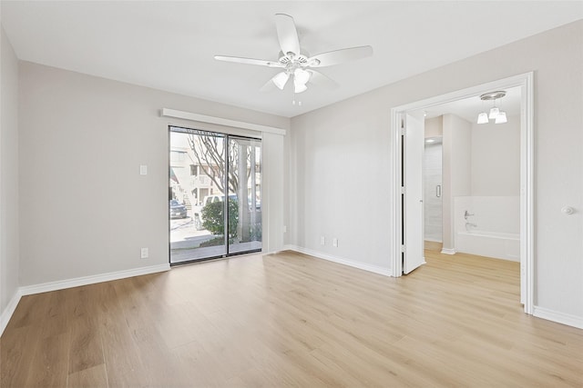 empty room with ceiling fan and light hardwood / wood-style flooring