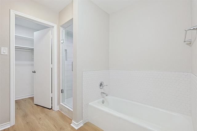 bathroom featuring wood-type flooring and independent shower and bath