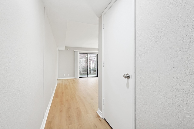 corridor with light wood-type flooring