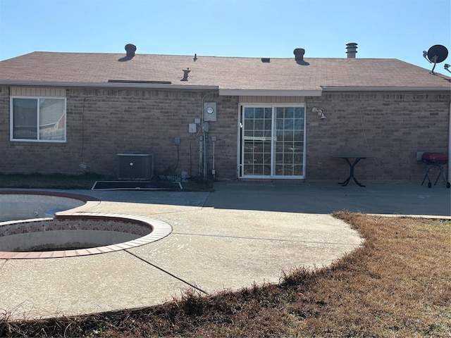 back of property featuring cooling unit and a patio area