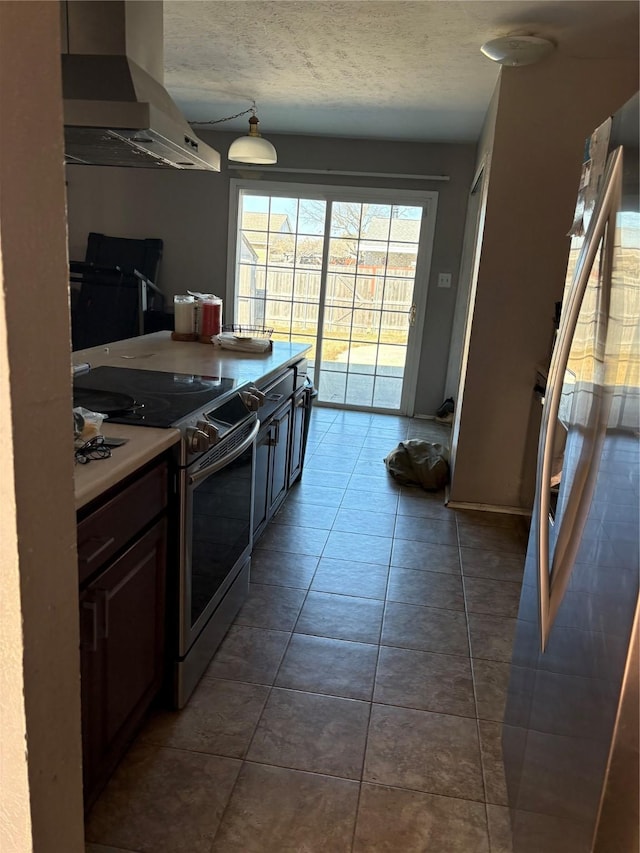 kitchen featuring dark tile patterned floors, dark brown cabinetry, a textured ceiling, island exhaust hood, and stainless steel electric stove