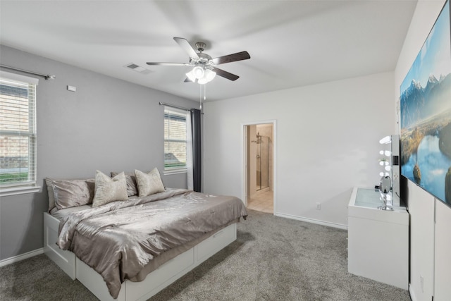 carpeted bedroom featuring ceiling fan and ensuite bath