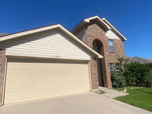 14029 Coyote Trl, Fort Worth, TX 76052 - traditional home featuring an attached garage, brick siding, and driveway