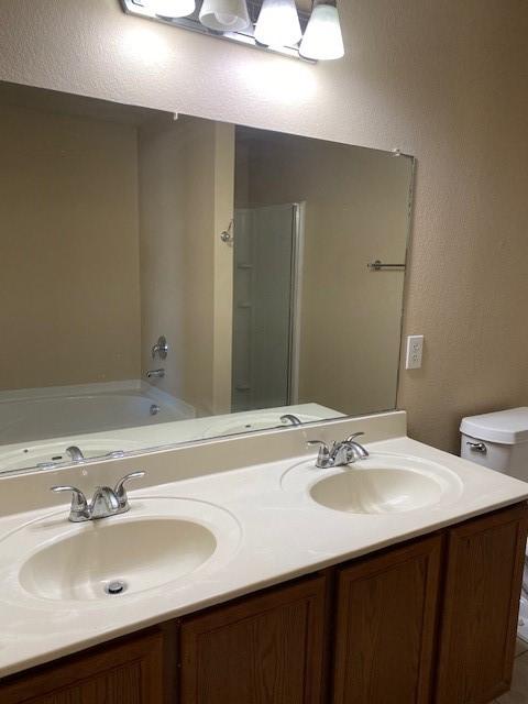 14029 Coyote Trl, Fort Worth, TX 76052 - bathroom with a sink, double vanity, and walk in shower
