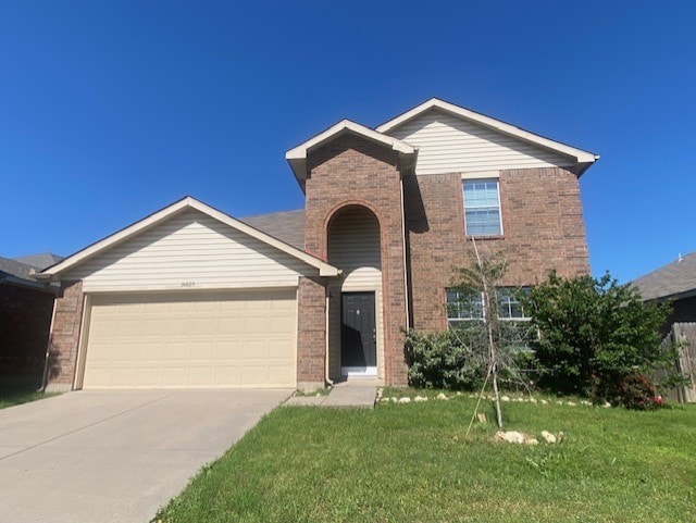 14029 Coyote Trl, Fort Worth, TX 76052 - traditional-style home featuring concrete driveway, a front yard, brick siding, and an attached garage