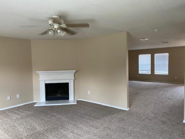 unfurnished living room featuring carpet and ceiling fan