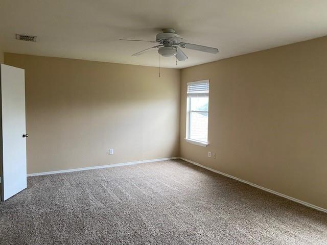 empty room with ceiling fan and carpet floors