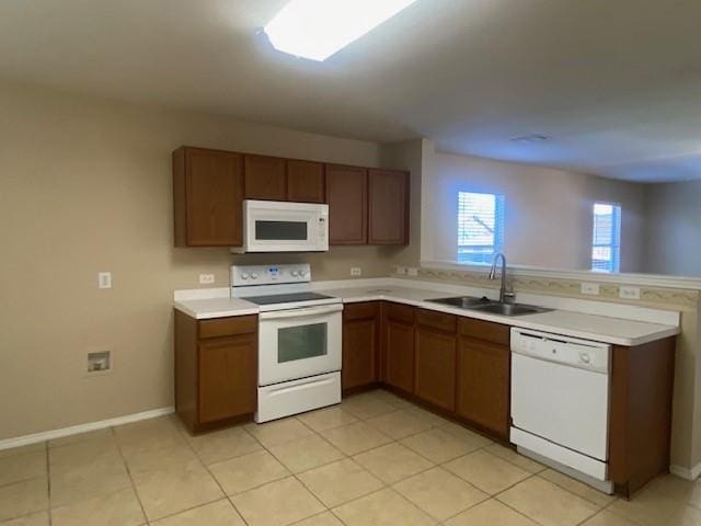 14029 Coyote Trl, Fort Worth, TX 76052 - kitchen featuring white appliances, light countertops, a peninsula, and a sink