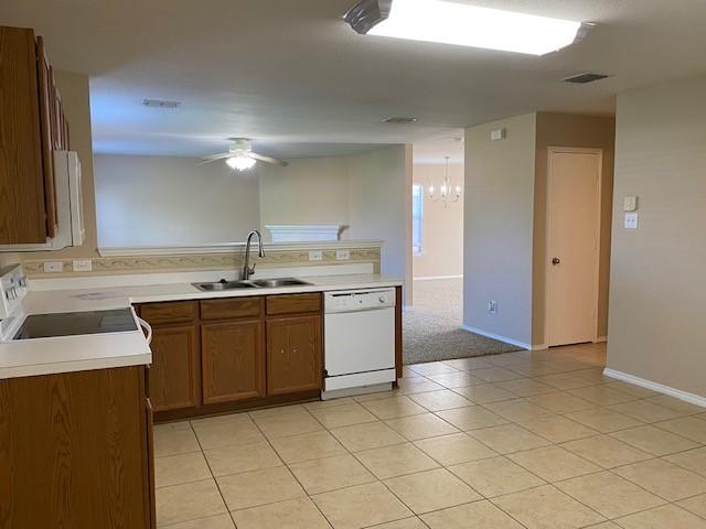 14029 Coyote Trl, Fort Worth, TX 76052 - kitchen featuring white appliances, visible vents, a sink, ceiling fan with notable chandelier, and brown cabinets