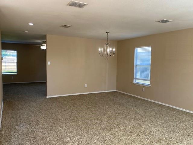 14029 Coyote Trl, Fort Worth, TX 76052 - unfurnished room with baseboards, visible vents, carpet, and ceiling fan with notable chandelier