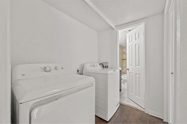 laundry room featuring dark wood-type flooring and washer and clothes dryer