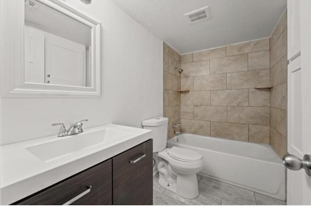 full bathroom featuring vanity, toilet, and tiled shower / bath combo