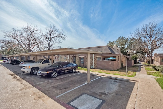 view of parking / parking lot featuring a carport