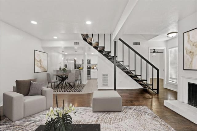 living room with hardwood / wood-style floors and ceiling fan