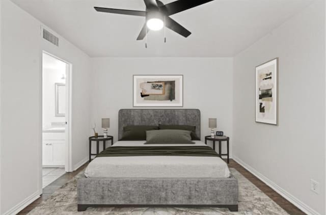 bedroom with hardwood / wood-style floors, ceiling fan, and ensuite bathroom