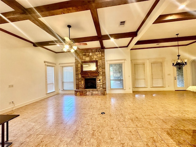 unfurnished living room with beamed ceiling, a stone fireplace, coffered ceiling, and ceiling fan with notable chandelier