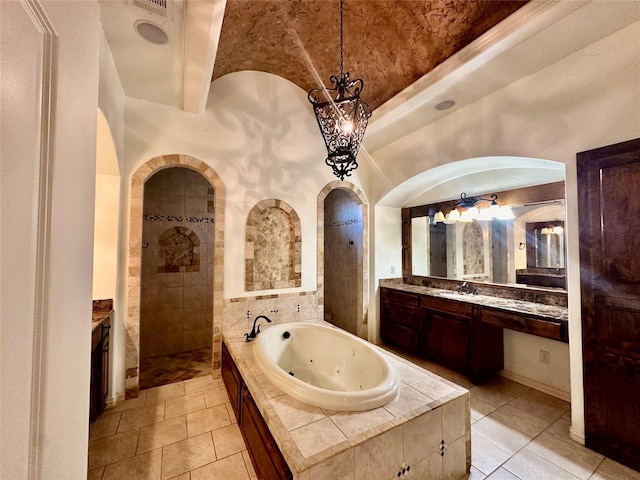 bathroom featuring independent shower and bath, vanity, and tile patterned floors