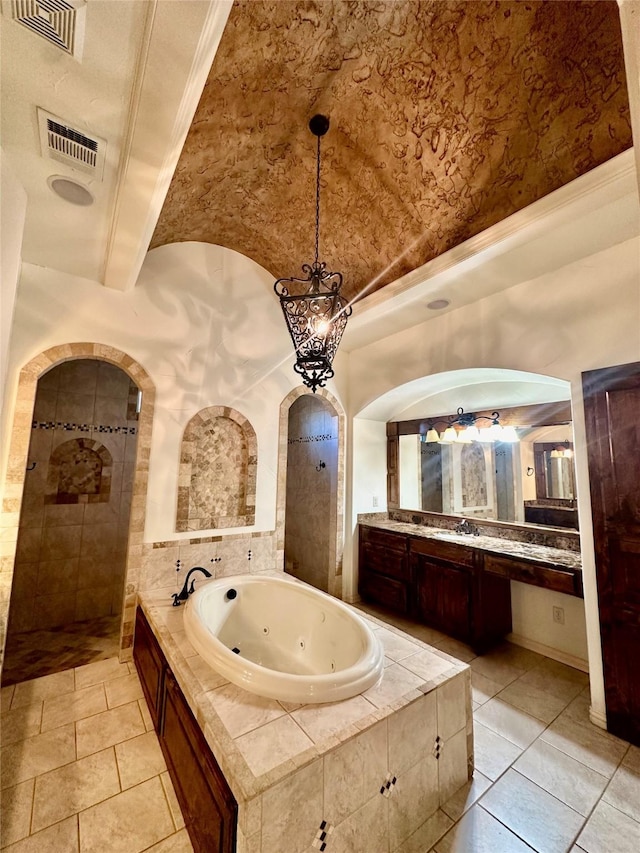 bathroom featuring tile patterned floors, vanity, shower with separate bathtub, and beam ceiling